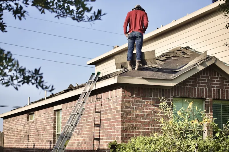 Professional roofer working on a residential roof in East Greenwich